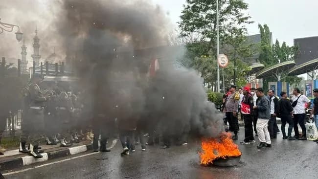 Foto​ aksi bakar ban, massa pendemo di depan Kantor Gubernur Kaltim menuntut pertanggungjawaban Pemprov atas krisis kesehatan akibat kabut asap karhutla